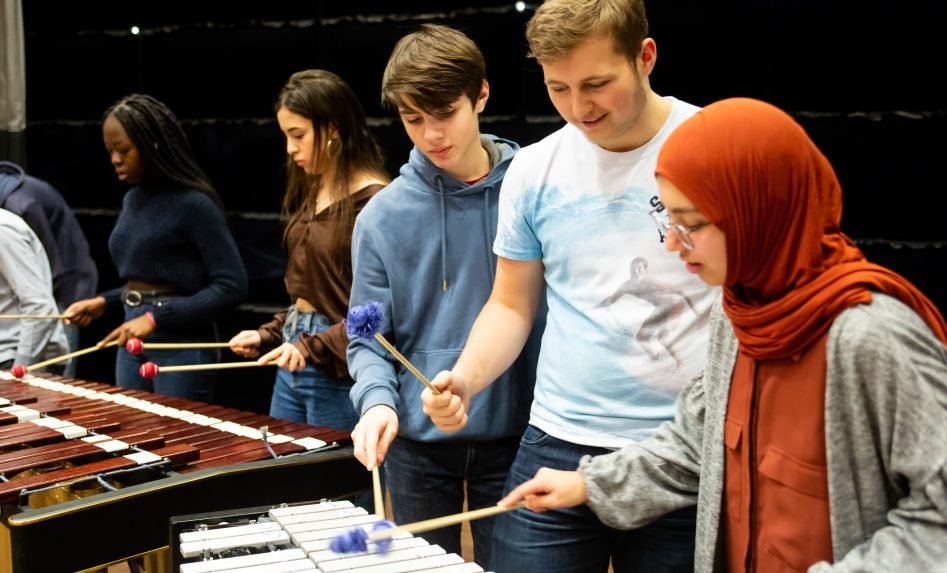 Students in a workshop with instruments