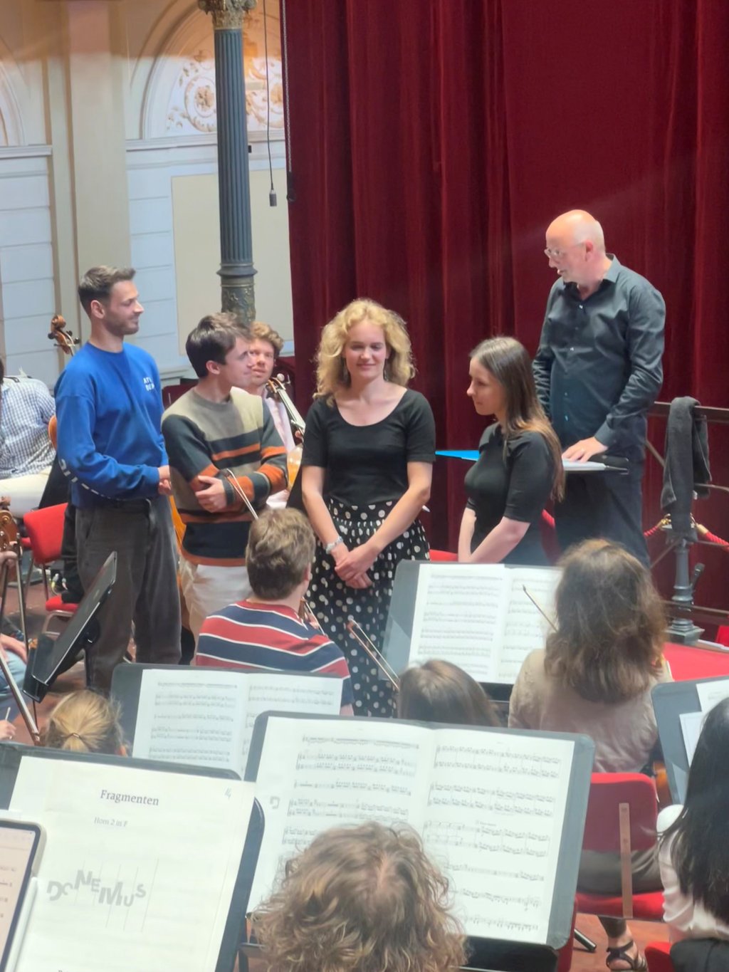 The four participants in the composers' workshop receive applause.