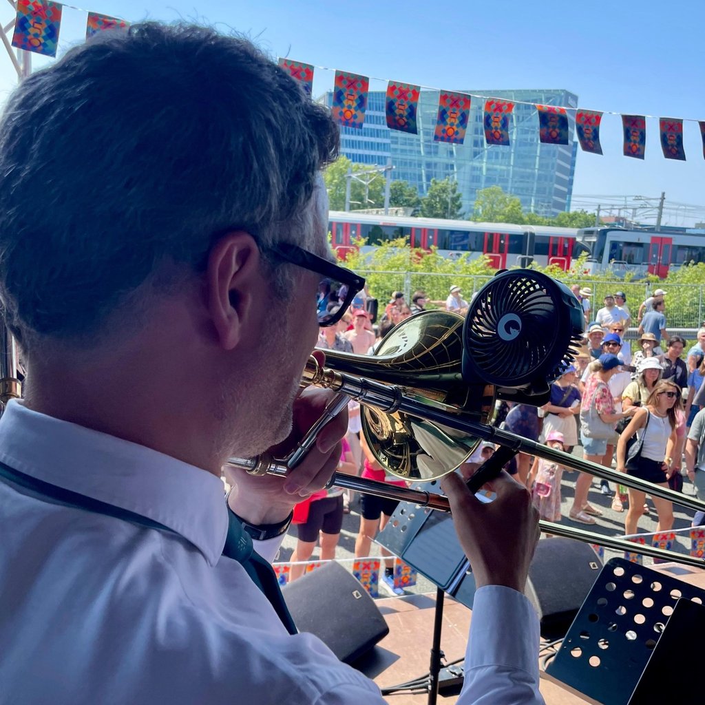 Trombonist Martin Schippers performs on the highway with a small fan attached to the instrument.